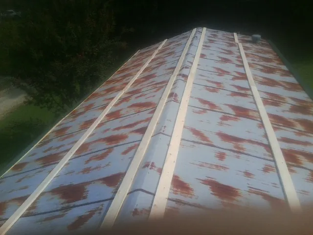 Rusted metal roof panels with new wood purlins before replacement — Storm Damage Roof Repair in Runnemede by Roofing Brothers