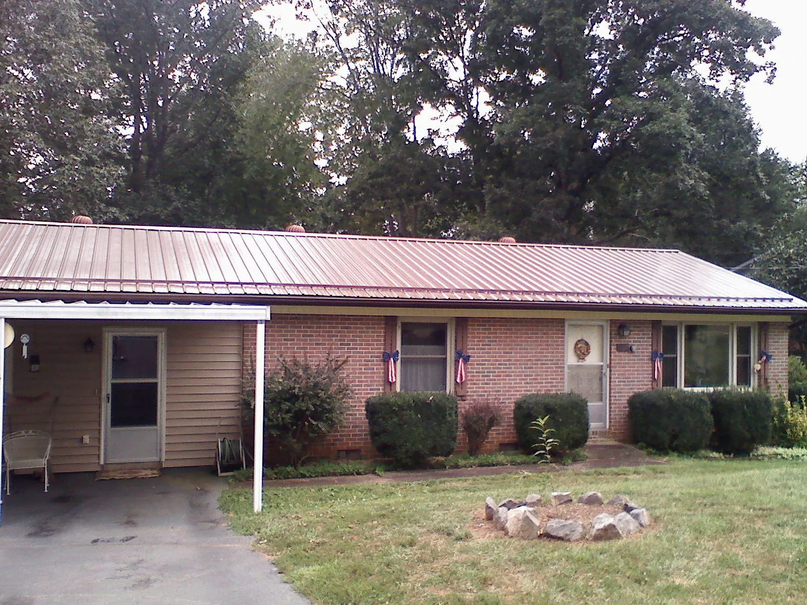 Bronze metal roof and carport on a brick ranch home — Roof Repair work by our crew in Runnemede